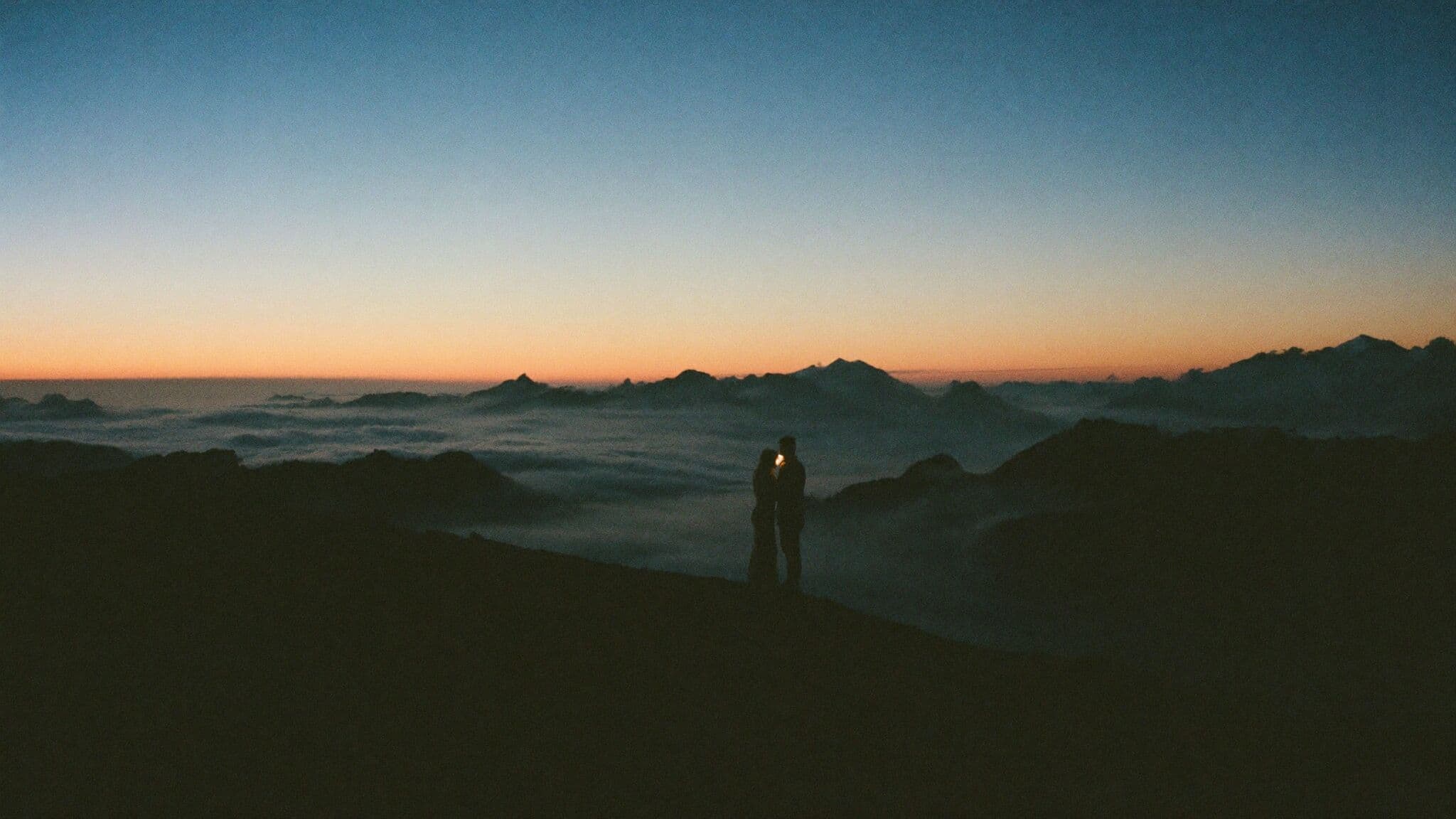 Couple hiking by headlamp before sunrise on their Colorado adventure elopement