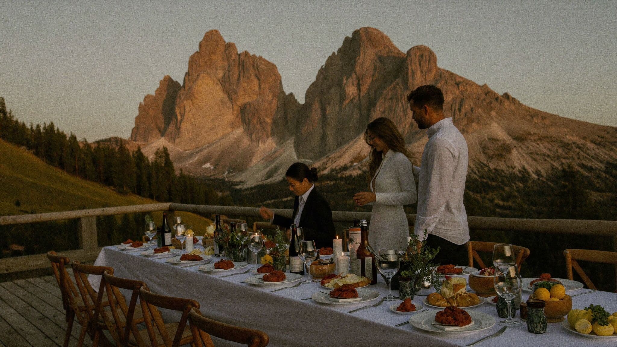 Newlyweds sharing a candlelit rifugio dinner in the mountains after their Dolomites elopement