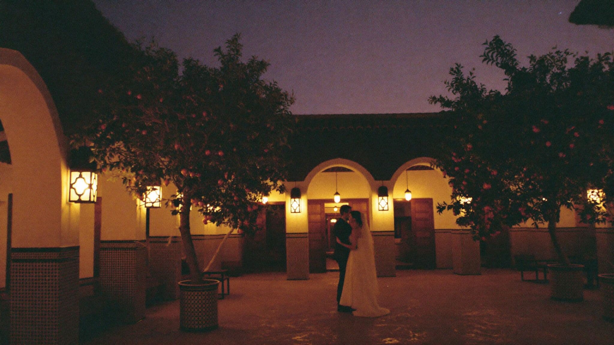 Bride and groom in a tiled riad courtyard in Marrakech before their Morocco elopement ceremony