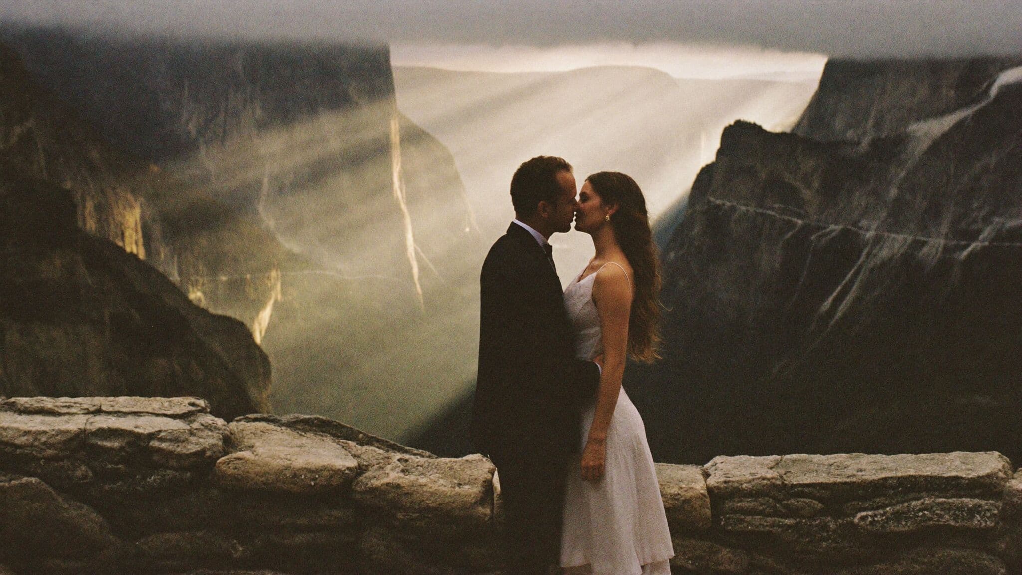 Couple at Tunnel View overlook during their Yosemite National Park elopement with El Capitan and Bridalveil Fall behind